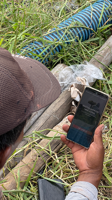 Field research in Java villages — farmer using phone